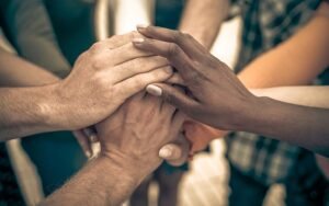 a picture showing people from all the races holding hands in unity